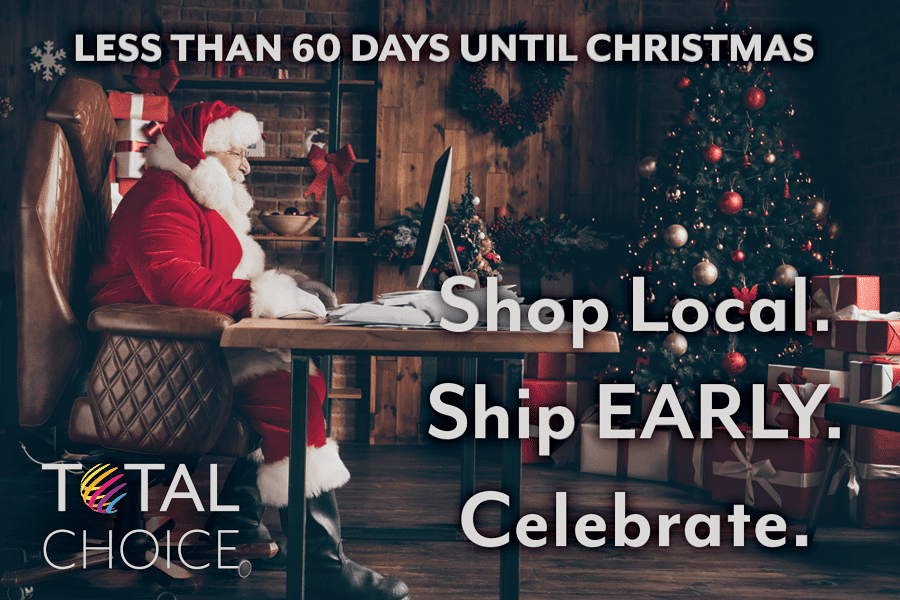 Santa sits at his desk in a cozy wooden room with a fully decked Christmas tree. Image text reads: Less than 60 days until Christmas. Shop Local. Ship Early. Celebrate. Total Choice Logo adorns the lower left of the image.